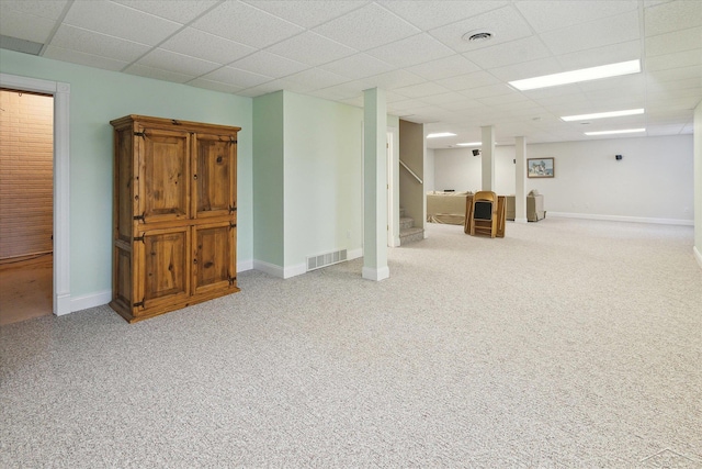 basement with carpet floors and a drop ceiling