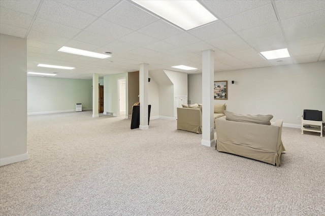 carpeted living room with a drop ceiling