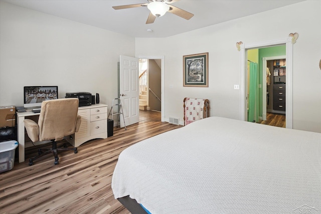 bedroom with ceiling fan, hardwood / wood-style flooring, and ensuite bath