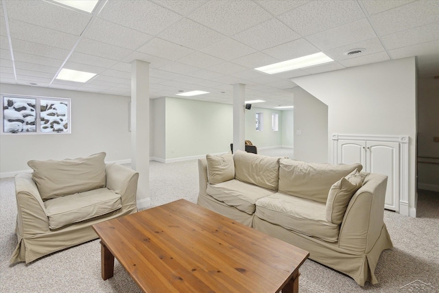 carpeted living room featuring a paneled ceiling