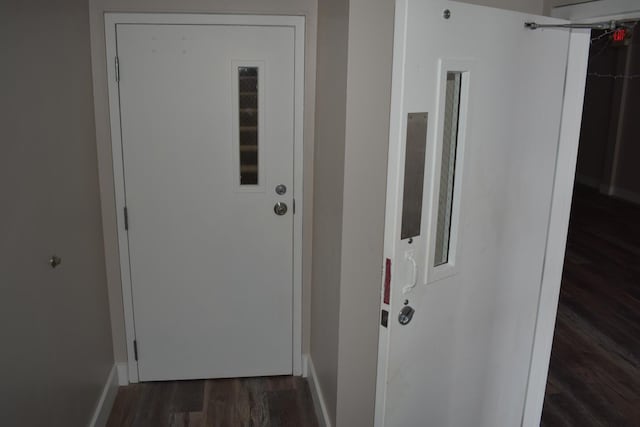 hallway with dark hardwood / wood-style floors