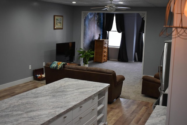 living room featuring ceiling fan and light colored carpet