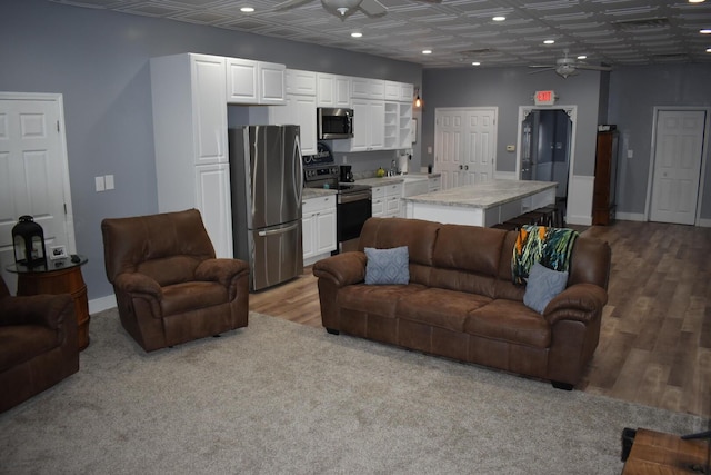 living room featuring ceiling fan and sink