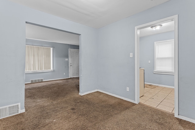 carpeted empty room with visible vents and baseboards