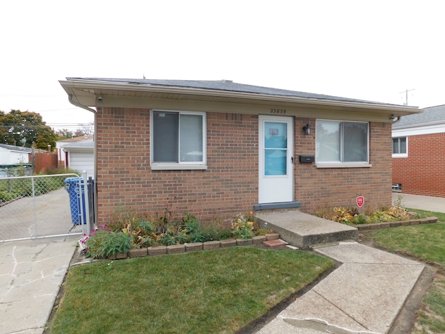 bungalow-style home featuring a front yard