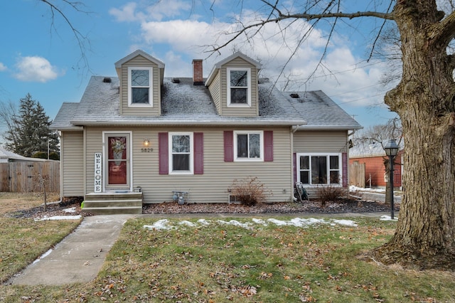 new england style home featuring a front lawn