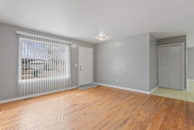 interior space with visible vents, baseboards, and light wood-style floors