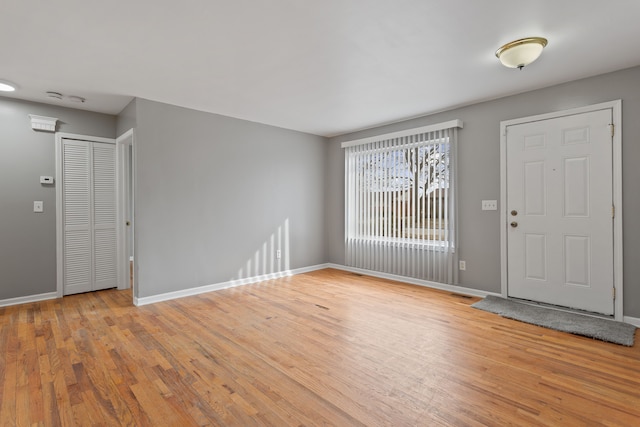 foyer with visible vents, baseboards, and light wood-style floors