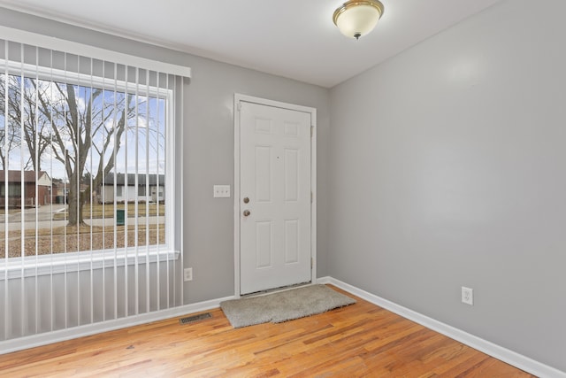 entrance foyer with visible vents, baseboards, and wood finished floors