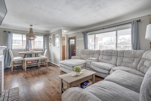 living room featuring dark hardwood / wood-style floors and a textured ceiling