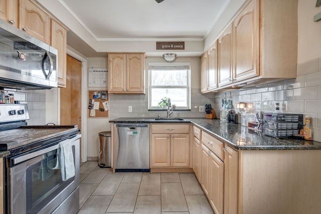 kitchen with stainless steel appliances, light tile patterned flooring, sink, and light brown cabinetry