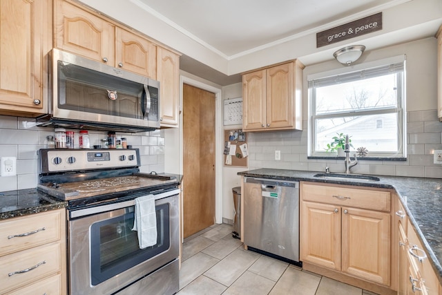 kitchen featuring sink, light tile patterned floors, appliances with stainless steel finishes, decorative backsplash, and light brown cabinets