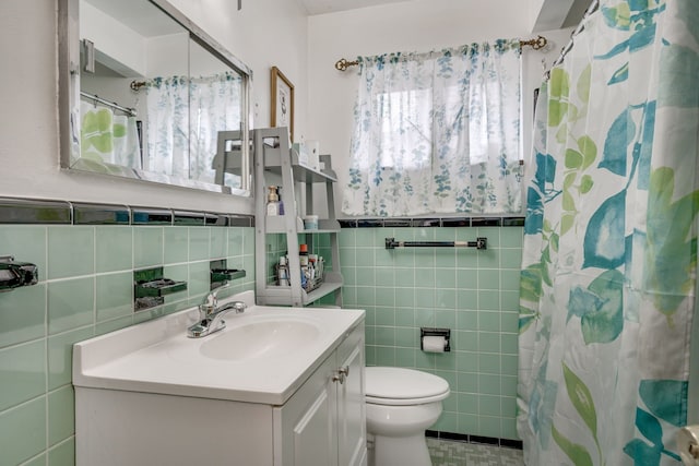 bathroom featuring tile walls, vanity, a shower with curtain, and toilet