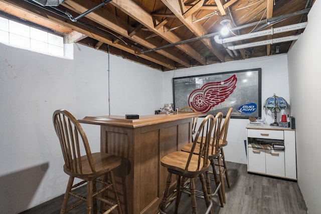 bar featuring dark wood-type flooring