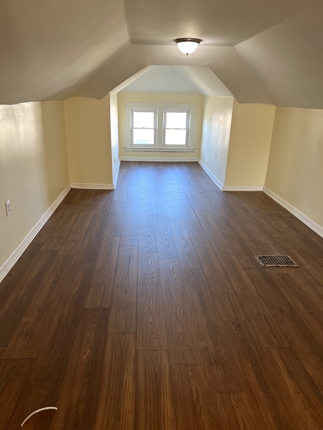 bonus room featuring dark wood-type flooring and lofted ceiling