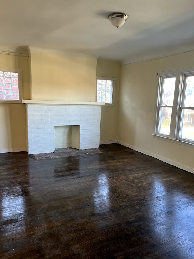 unfurnished room featuring a brick fireplace