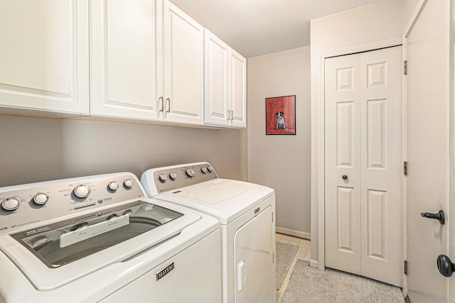 washroom featuring washer and dryer and cabinets