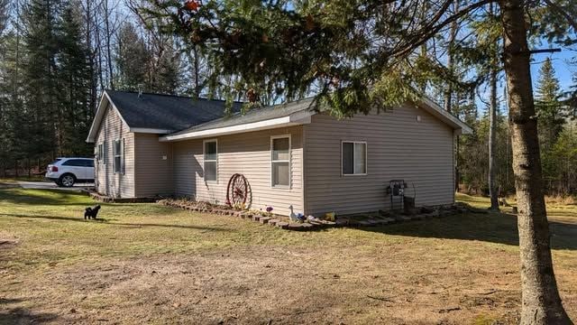 view of home's exterior with a lawn