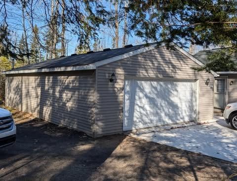 view of home's exterior with an outdoor structure and a garage