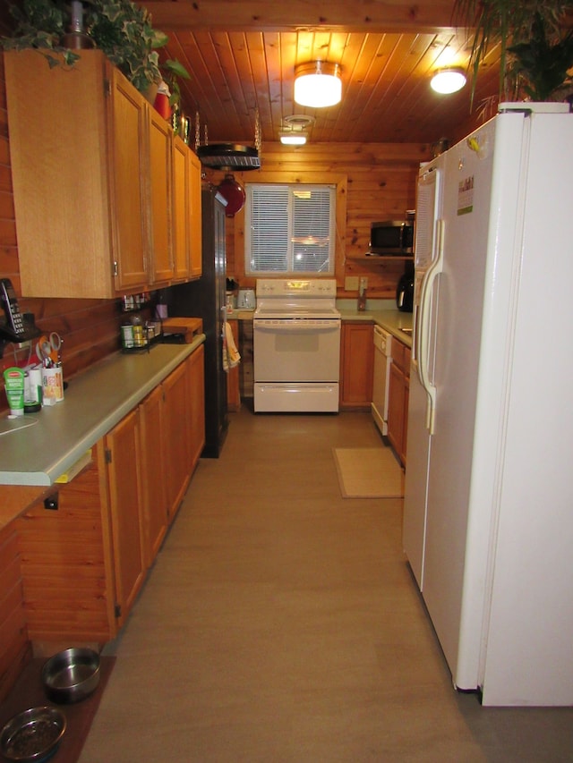 kitchen with wood walls, white appliances, and wooden ceiling