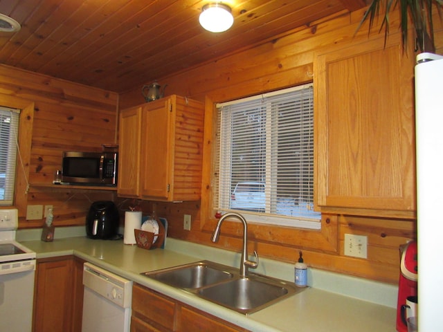 kitchen with sink, white appliances, wood walls, and wood ceiling