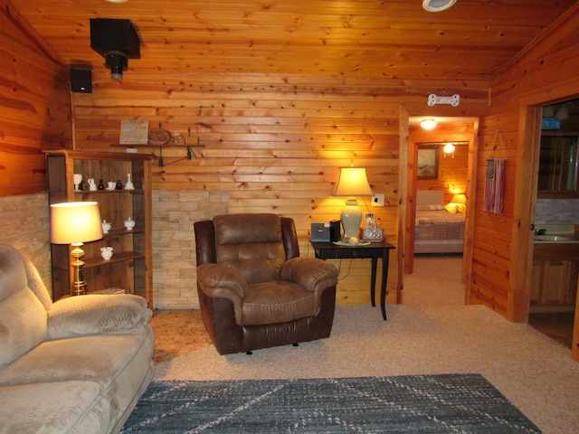 sitting room featuring carpet floors, wood ceiling, and vaulted ceiling