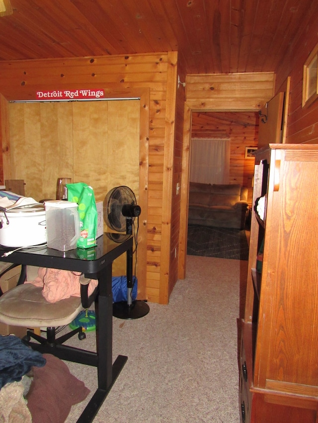 office with light carpet, wooden ceiling, and wooden walls