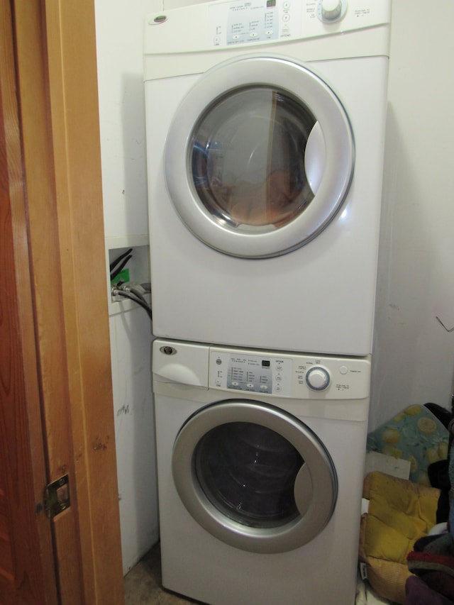 washroom with stacked washer / drying machine