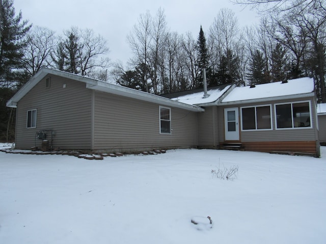 view of snow covered back of property