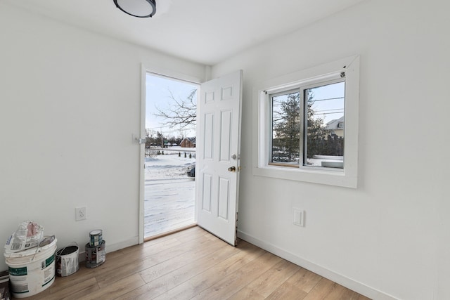 doorway with light wood-type flooring