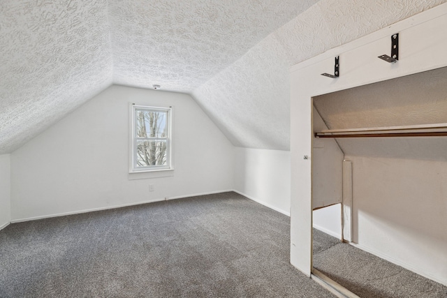 bonus room featuring lofted ceiling, carpet flooring, and a textured ceiling