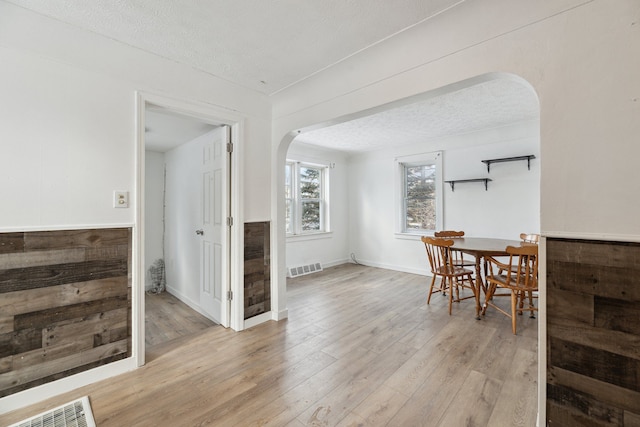 dining area featuring light hardwood / wood-style flooring and a textured ceiling