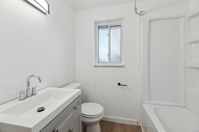 bathroom with vanity, wood-type flooring, and toilet