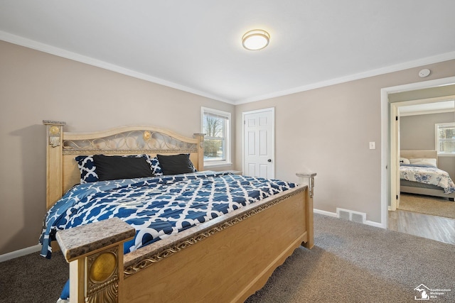 bedroom with ornamental molding and carpet floors