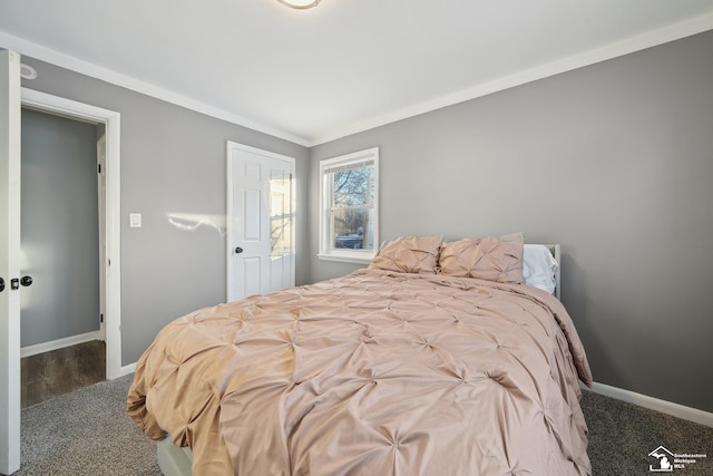 bedroom with crown molding and dark carpet