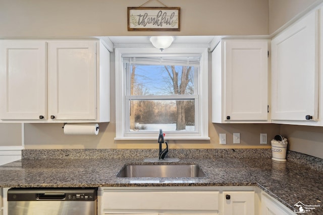 kitchen featuring white cabinets, dishwasher, sink, and dark stone counters