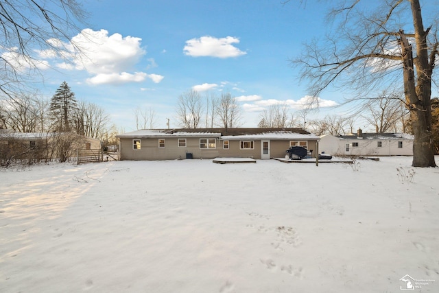 view of snow covered back of property