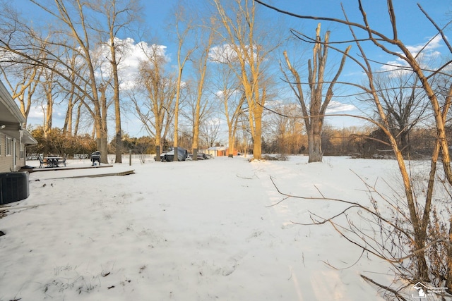 yard covered in snow featuring central air condition unit