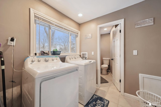 laundry room featuring light tile patterned floors and washer and dryer