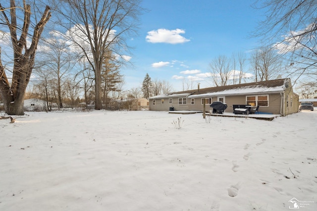 view of snow covered back of property