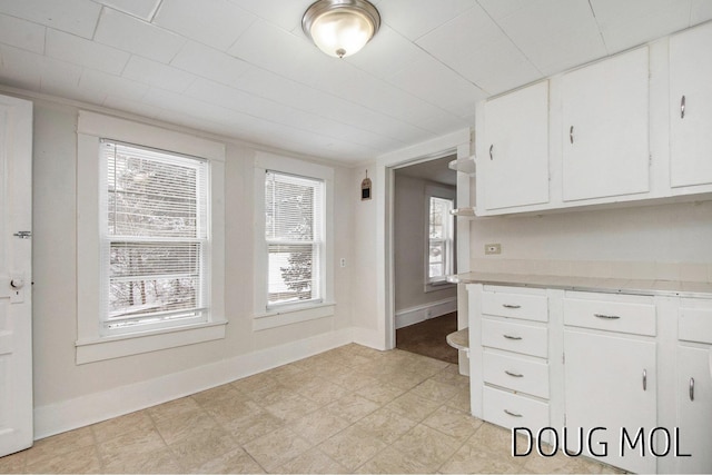 kitchen featuring plenty of natural light and white cabinets