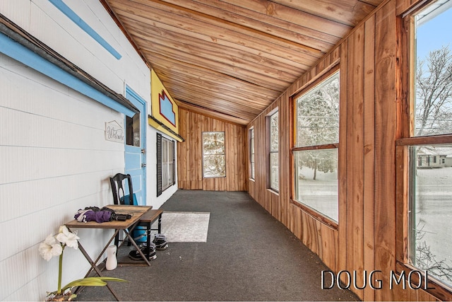 unfurnished sunroom featuring wooden ceiling and vaulted ceiling