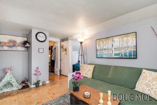 living room featuring parquet flooring and a textured ceiling