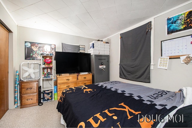 carpeted bedroom with ornamental molding