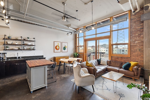 living room with sink and brick wall