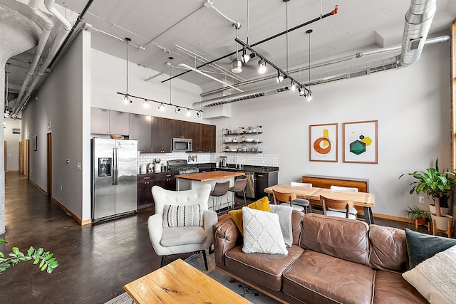 living room with sink and a high ceiling