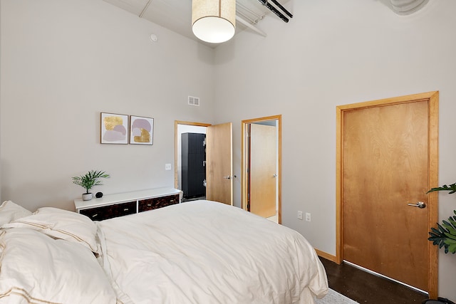 bedroom featuring a towering ceiling