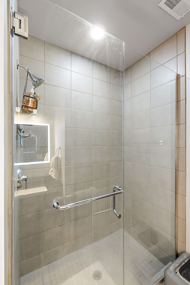 bathroom with a shower with shower door