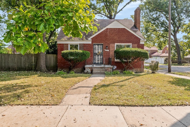 bungalow-style house featuring a front yard