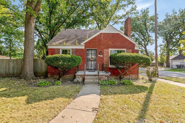 bungalow-style house featuring a front lawn